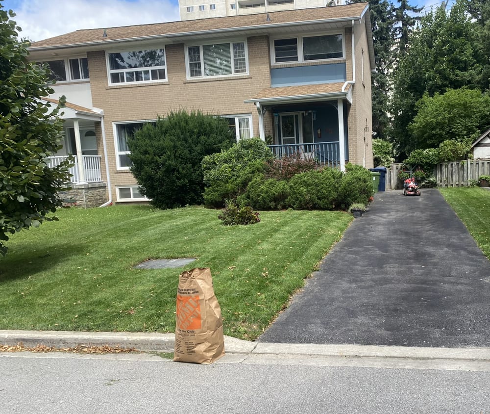 Front lawn mowed with yard waste bagged at the curb