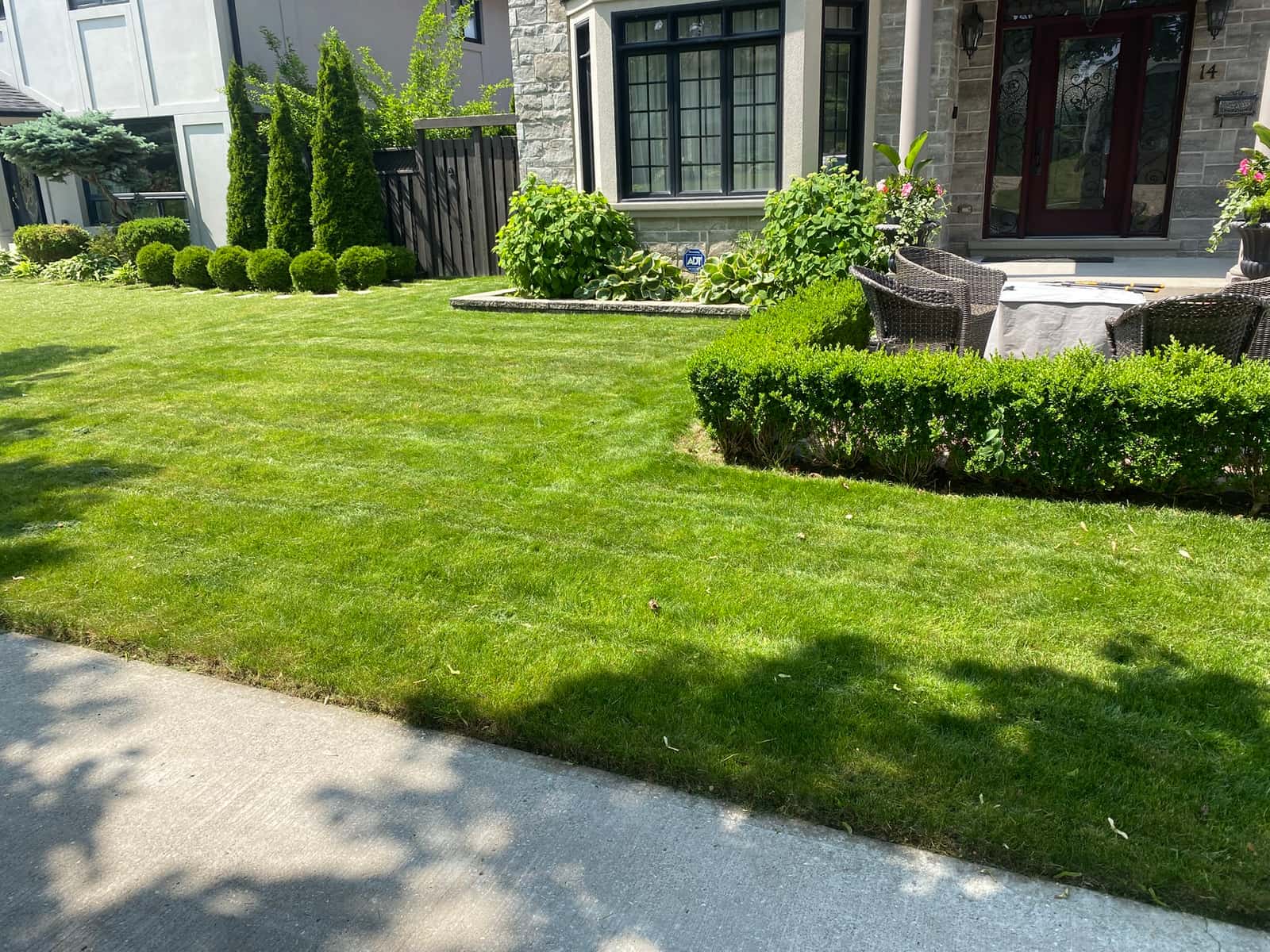 Student mowing a front lawn
